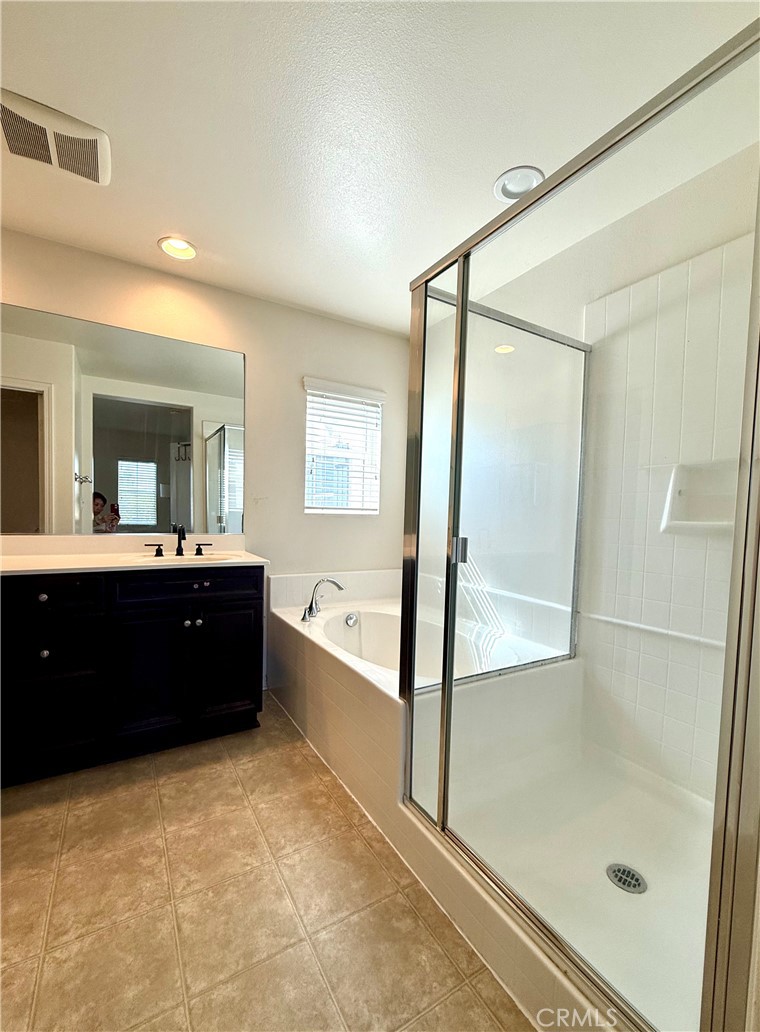 14540 Manchester Avenue Chino, CA 91710 - Photo 13 of 22 a bathroom with a bathtub sink vanity and mirror