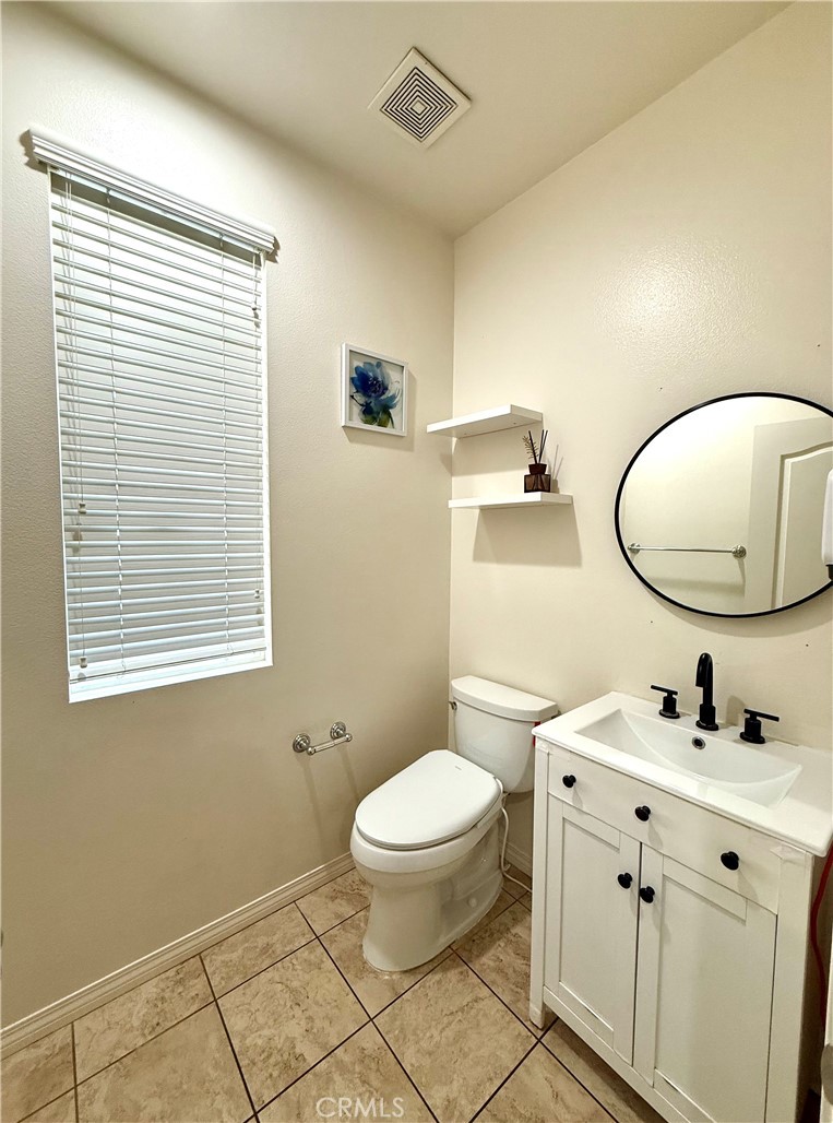 14540 Manchester Avenue Chino, CA 91710 - Photo 19 of 22 a bathroom with a toilet a sink and a mirror