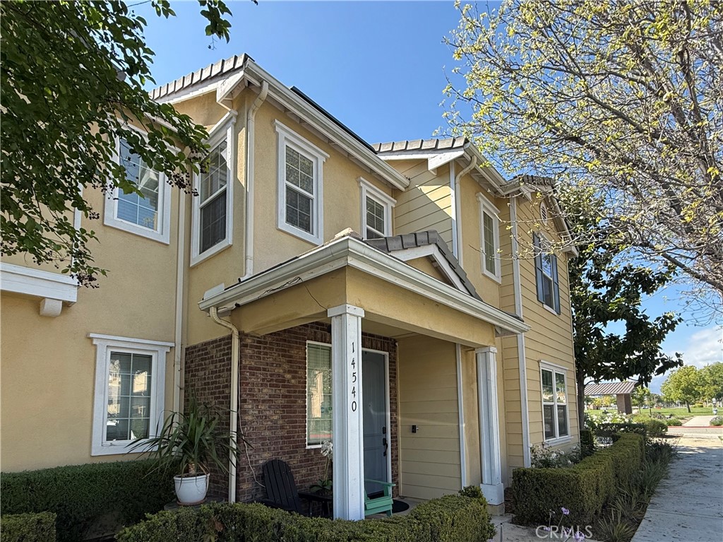 14540 Manchester Avenue Chino, CA 91710 - Photo 2 of 22 a front view of a house with a garden
