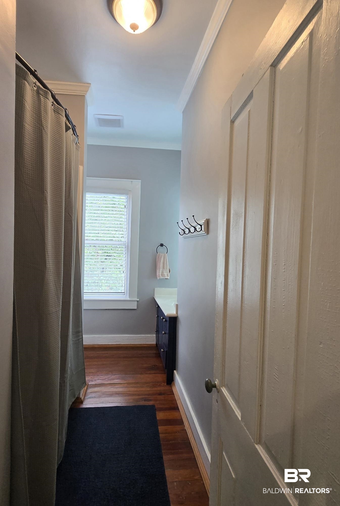 54 South Catherine Street Mobile, AL 36604 - Photo 40 of 55 Full bathroom with wood finished floors, crown molding, baseboards, vanity, and curtained shower
