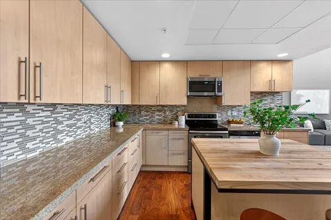 a kitchen with sink a stove and cabinets