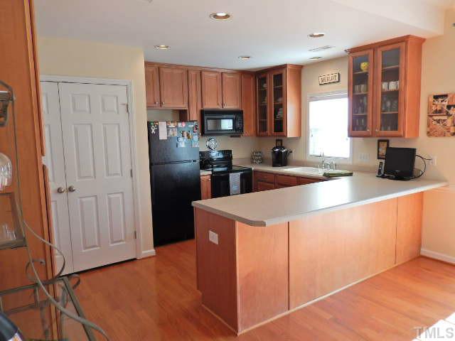 2131 Piney Brook Road, Unit 106 Raleigh, NC 27614 - Photo 6 of 23 a kitchen with stainless steel appliances granite countertop a refrigerator oven a sink dishwasher and a refrigerator