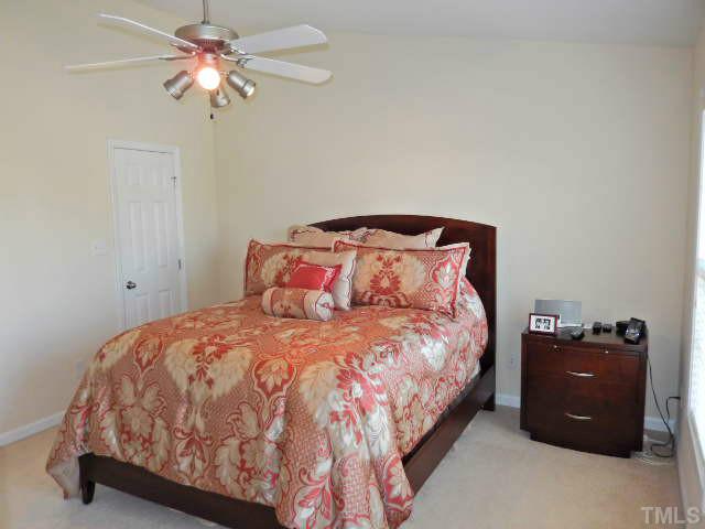2131 Piney Brook Road, Unit 106 Raleigh, NC 27614 - Photo 8 of 23 a bedroom with a bed and a chandelier
