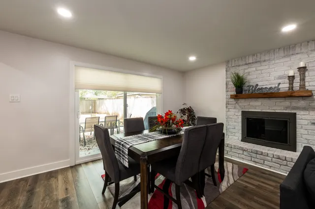a view of a dining room with furniture and a fireplace
