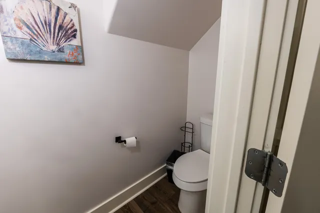 a white toilet sitting next to a small sink