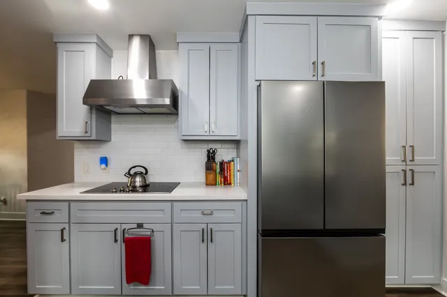 a kitchen with a sink cabinets stainless steel appliances and a window