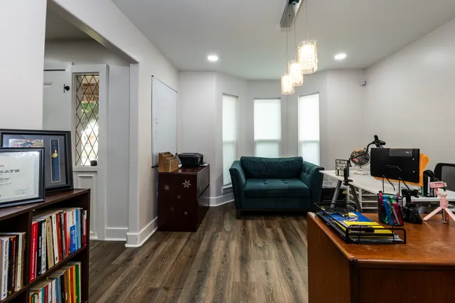 a living room with furniture and wooden floor