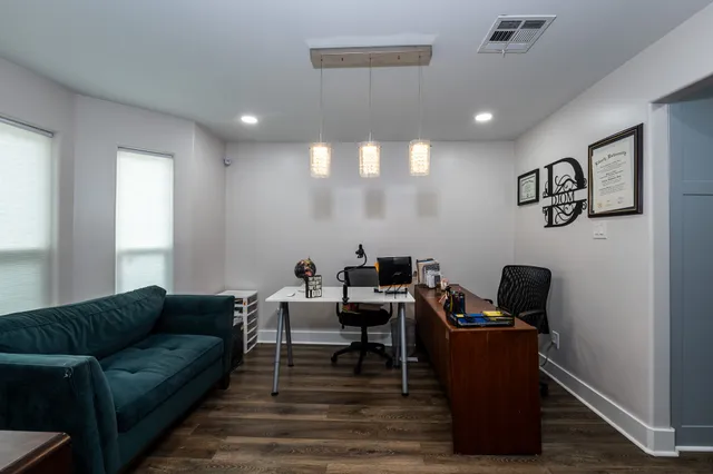 a view of entryway and hall with wooden floor