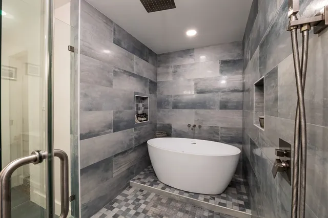 a bathroom with double vanity and a mirror