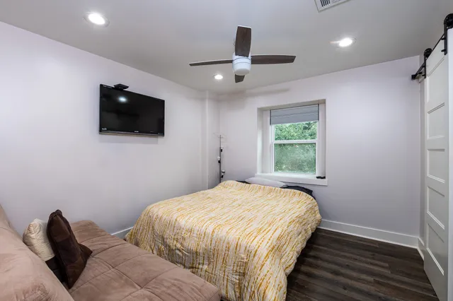 a bedroom with a bed and a flat screen tv