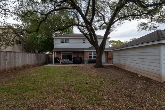 a view of house with outdoor space and trees