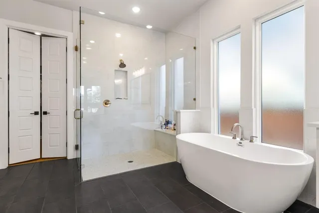 a bathroom with a bathtub and shower
