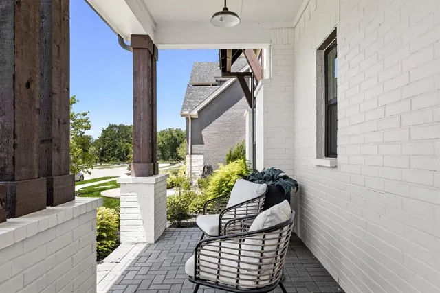 a balcony with potted plants and wooden floor