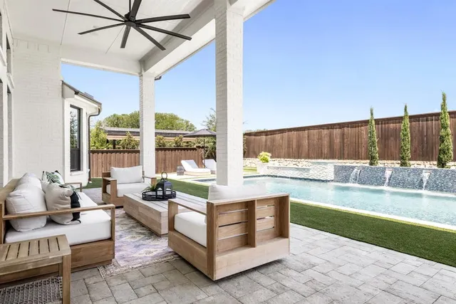 a living room with couch floor to ceiling window and a dining table