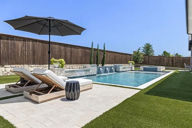 swimming pool view with a seating space