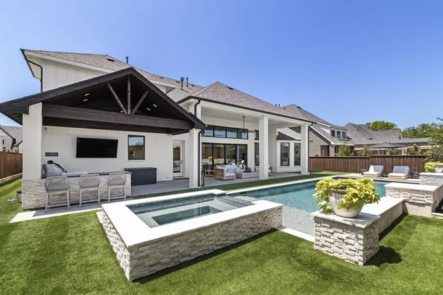 a front view of a house with swimming pool having outdoor seating