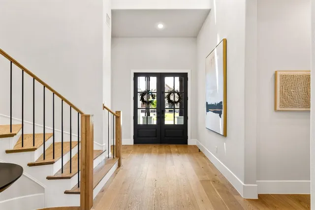 a view of an entryway with wooden floor and door