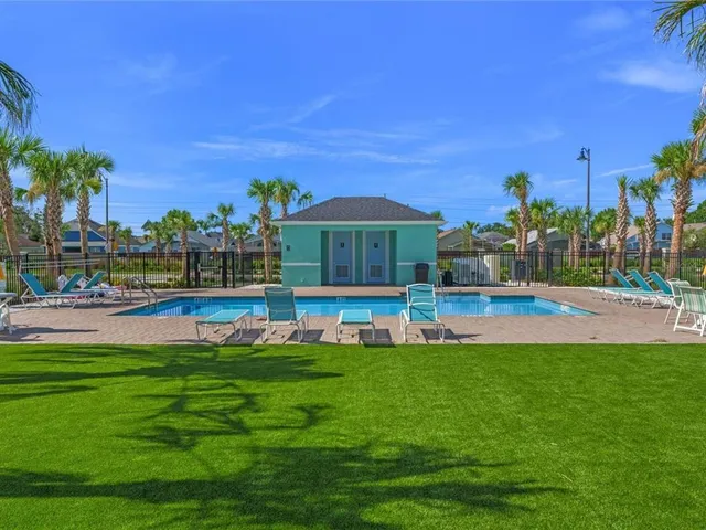 a view of swimming pool with outdoor seating and yard
