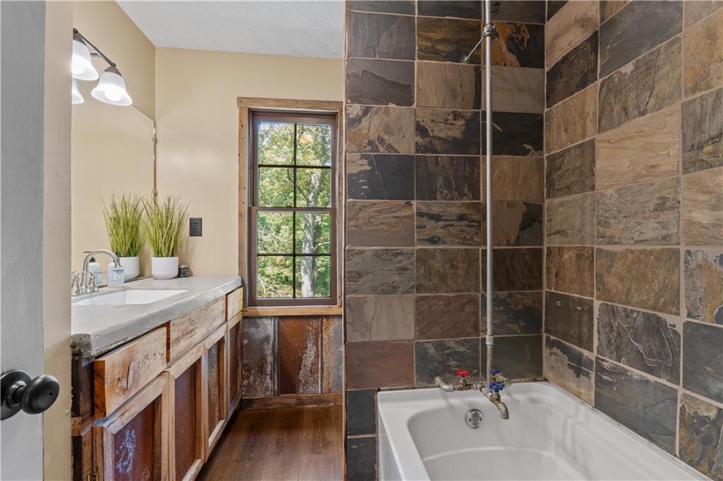 112 Brannon Road Buchanan, GA 30113 - Photo 25 of 40 a bathroom with a tub sink and mirror