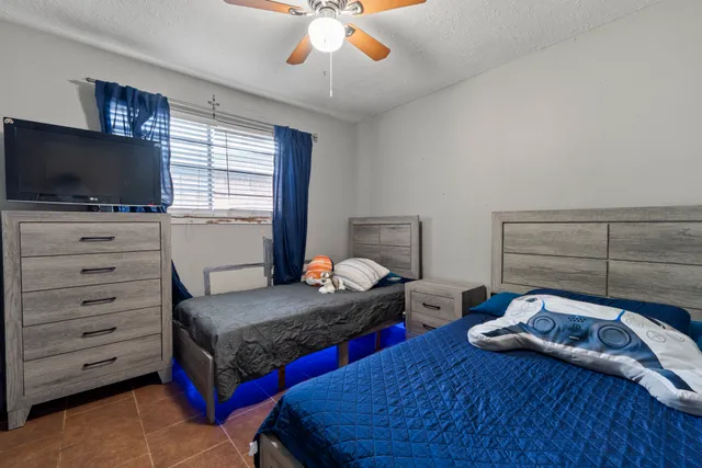a bedroom with bed and a flat screen tv