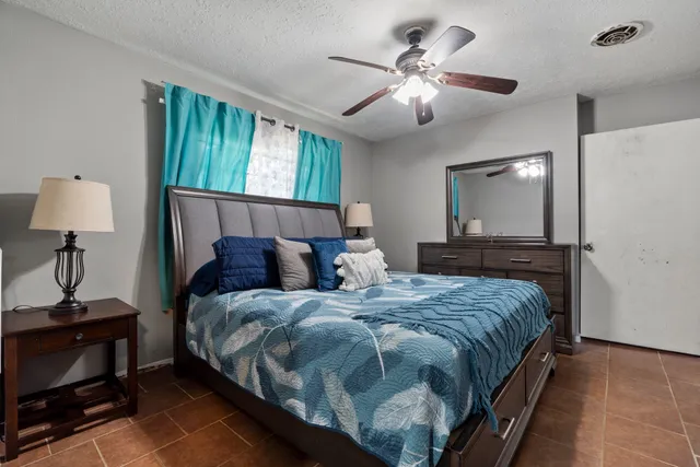 a large bedroom with a bed and a chandelier