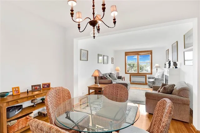 a living room with furniture a rug and a chandelier