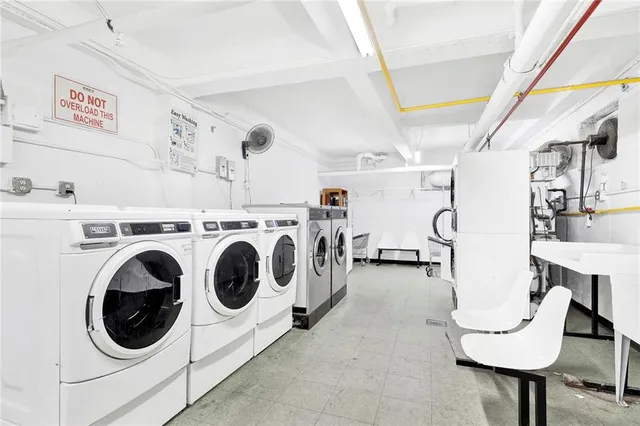 a utility room with cabinets dryer and washer