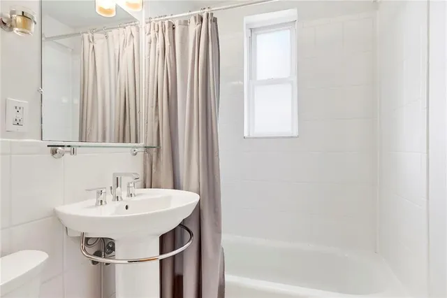 a bathroom with a sink a mirror and a bathtub