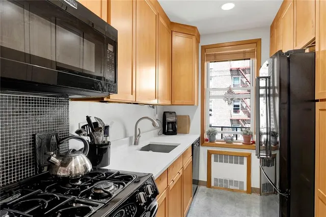 a kitchen with a sink a stove and cabinets