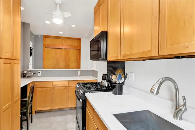 a kitchen with a sink a stove and cabinets