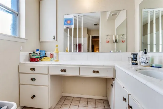 a bathroom with a sink vanity and mirror