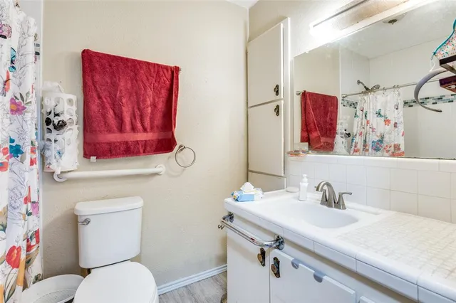 a bathroom with a toilet sink and mirror