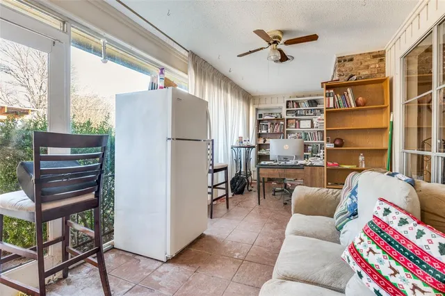 a living room with furniture a ceiling fan and a window