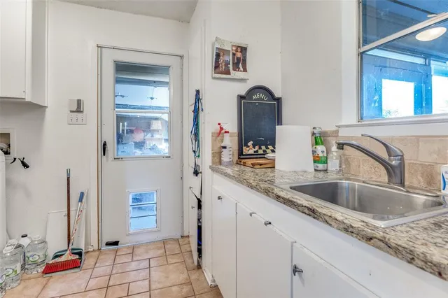 a kitchen with a sink and a refrigerator