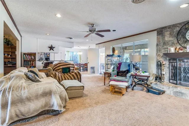 a bedroom with furniture and a large window