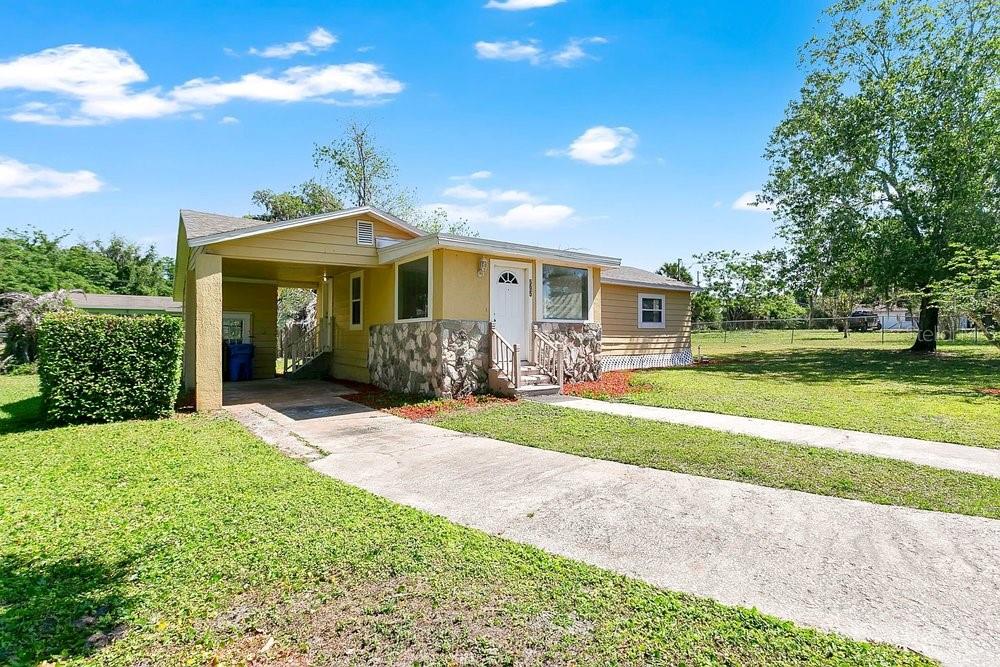 595 3rd Street Oviedo, FL 32765 - Photo 3 of 27 a front view of a house with a yard and potted plants