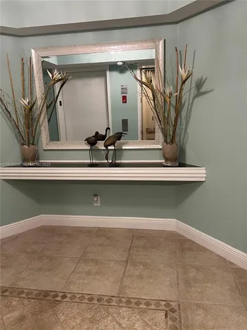 a living room with furniture and a view of kitchen