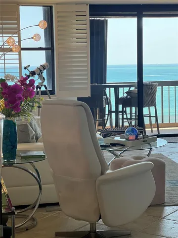 a living room with couches chairs and kitchen view