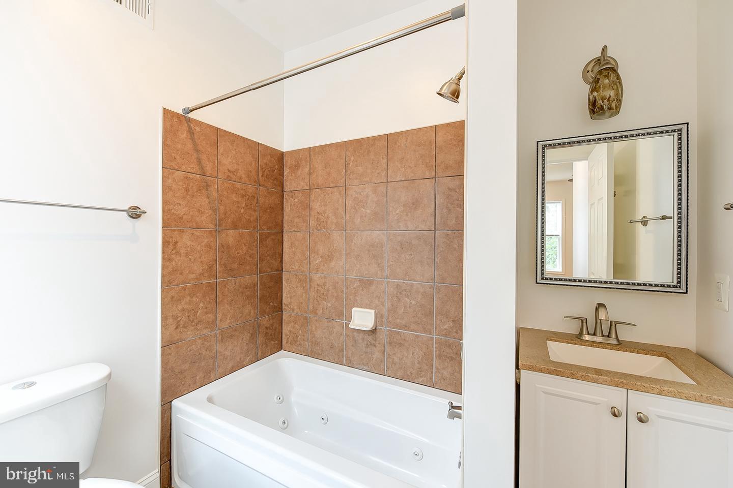 14 Florida Avenue Northeast Washington, DC 20002 - Photo 17 of 31 a bathroom with a granite countertop sink a toilet and shower