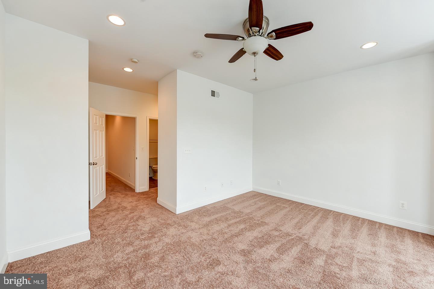 14 Florida Avenue Northeast Washington, DC 20002 - Photo 19 of 31 wooden floor in an empty room with a ceiling fan