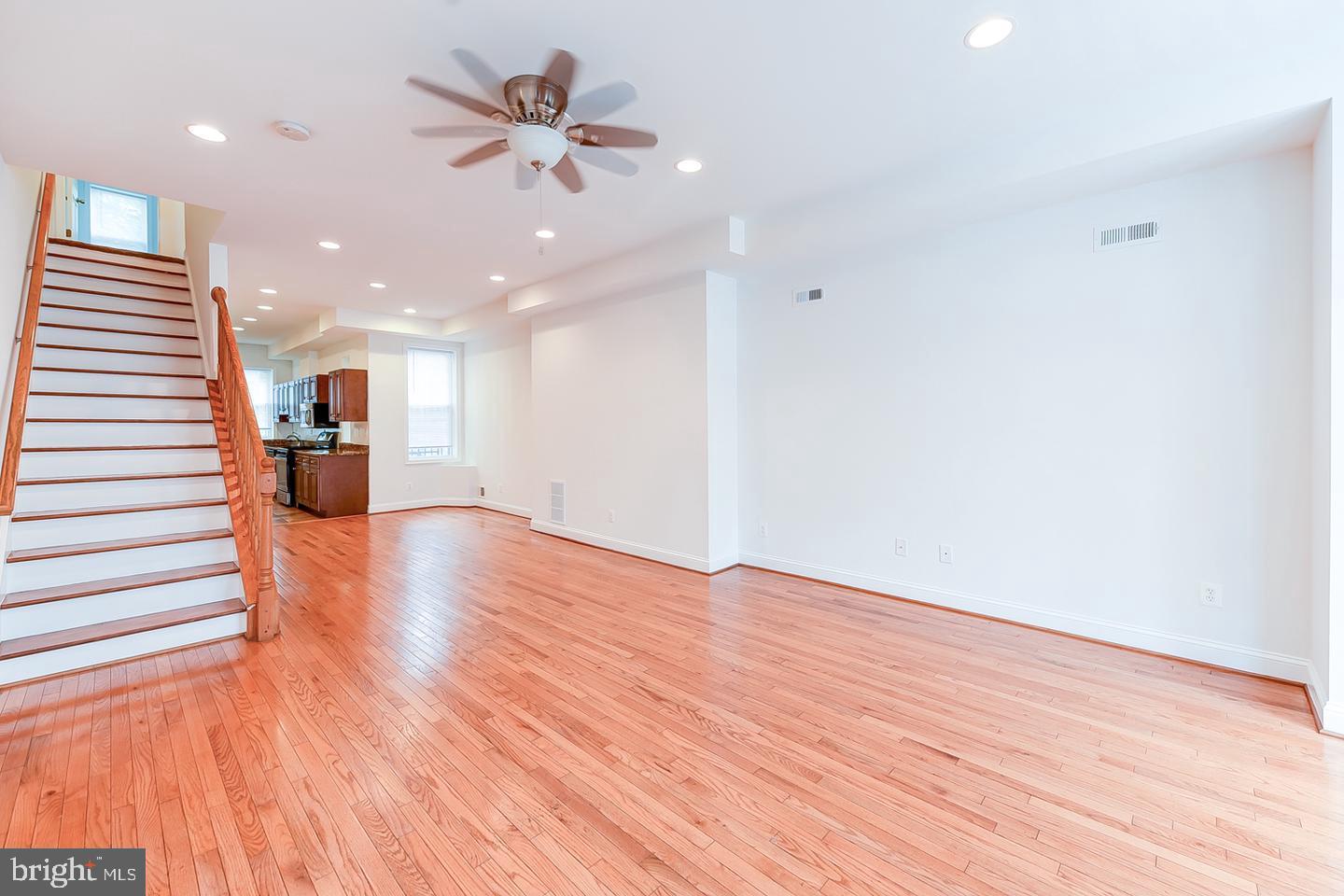 14 Florida Avenue Northeast Washington, DC 20002 - Photo 2 of 31 a view of an empty room with wooden floor and a ceiling fan