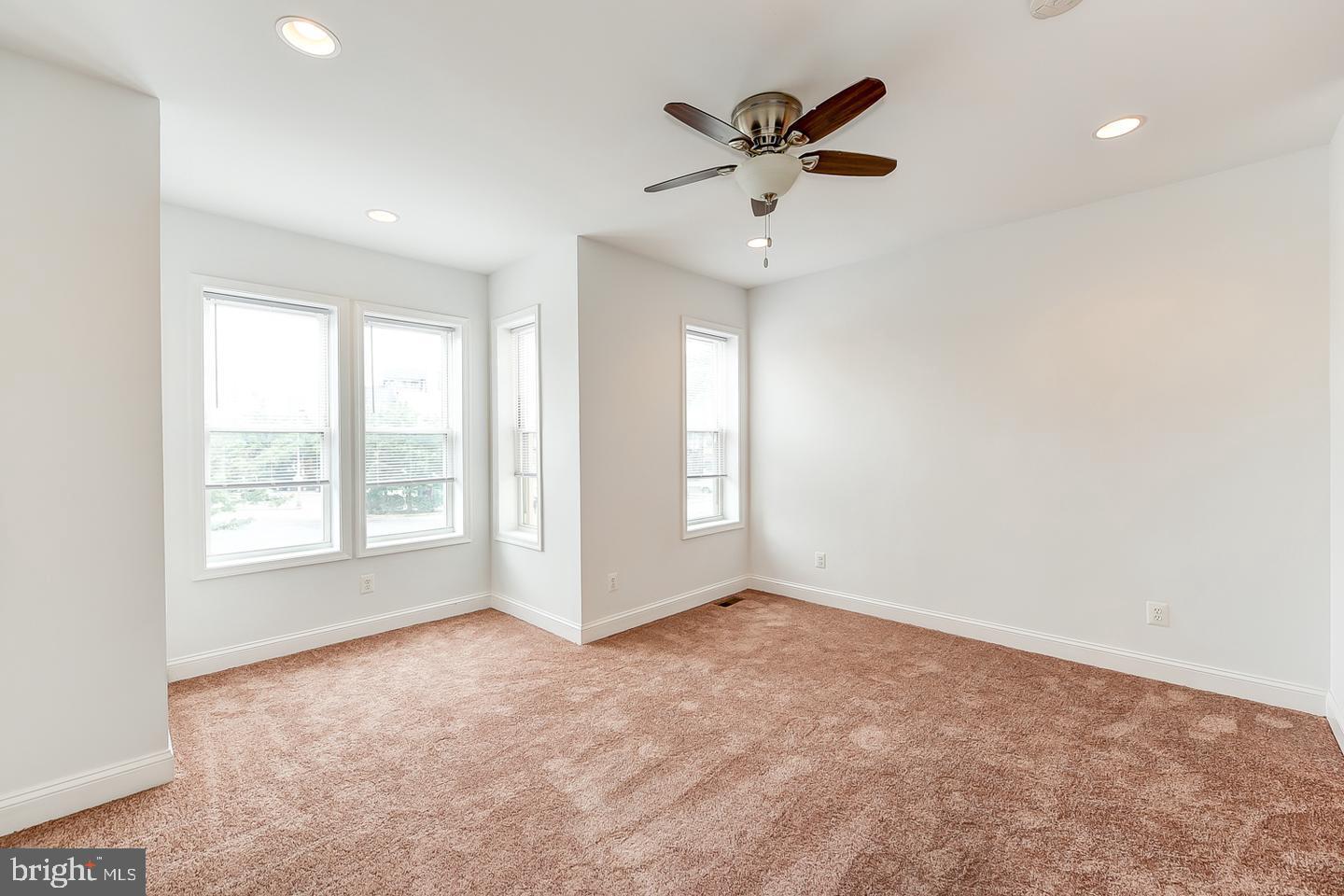 14 Florida Avenue Northeast Washington, DC 20002 - Photo 21 of 31 an empty room with windows and fan