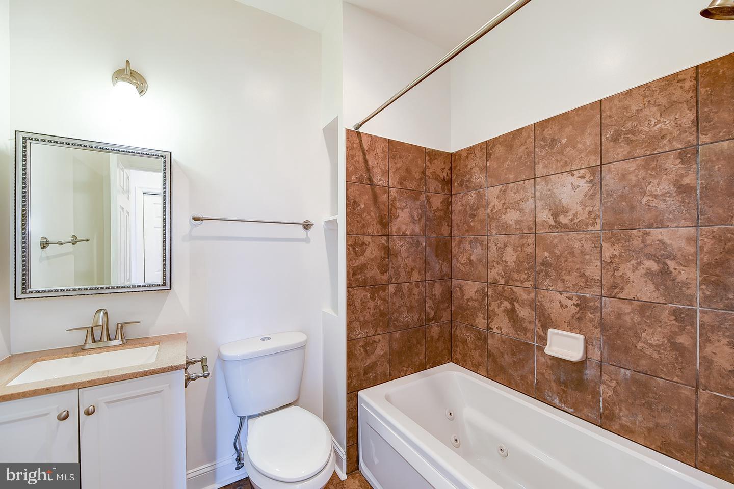 14 Florida Avenue Northeast Washington, DC 20002 - Photo 23 of 31 a bathroom with a granite countertop sink a toilet and shower