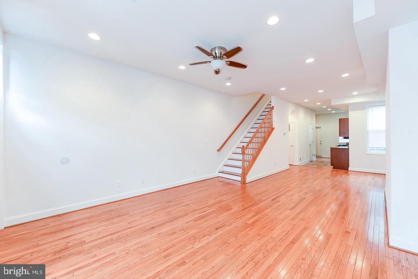 14 Florida Avenue Northeast Washington, DC 20002 - Photo 3 of 31 a view of an empty room with wooden floor stairs and a way to kitchen