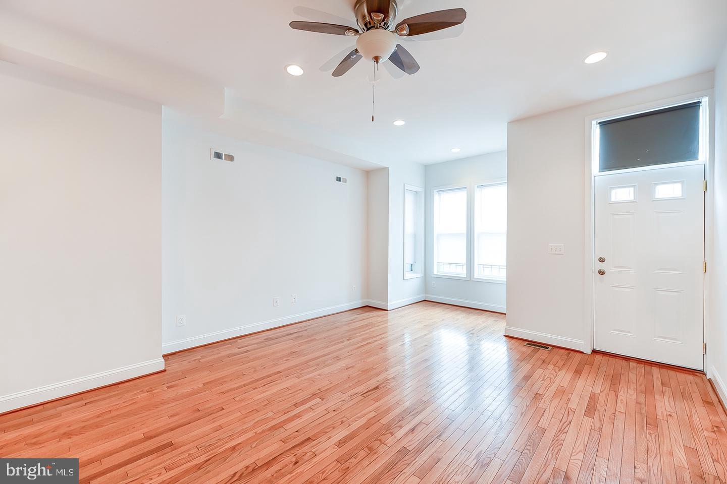 14 Florida Avenue Northeast Washington, DC 20002 - Photo 5 of 31 a view of an empty room with window and wooden floor