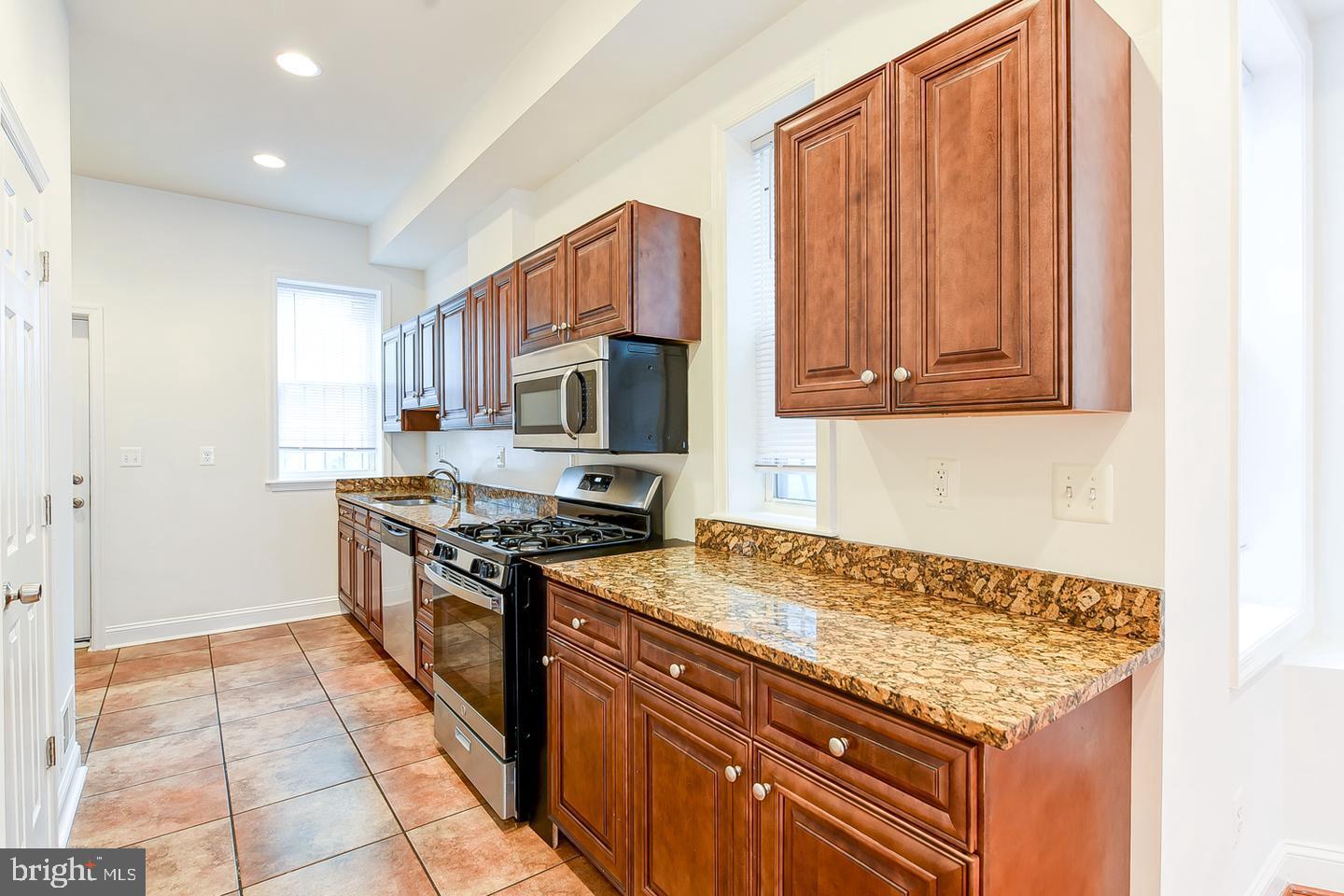 14 Florida Avenue Northeast Washington, DC 20002 - Photo 10 of 31 a kitchen with stainless steel appliances granite countertop a stove a sink dishwasher and a refrigerator