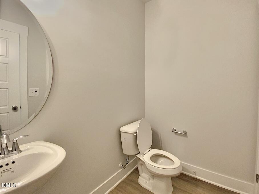 1309 Holding Village Way Wake Forest, NC 27587 - Photo 16 of 28 a white toilet sitting next to a bathroom sink