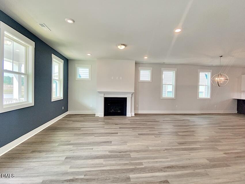 1309 Holding Village Way Wake Forest, NC 27587 - Photo 18 of 28 a view of an empty room with wooden floor and a window