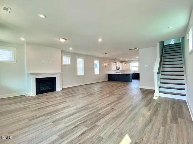 a view of kitchen and hall with wooden floor