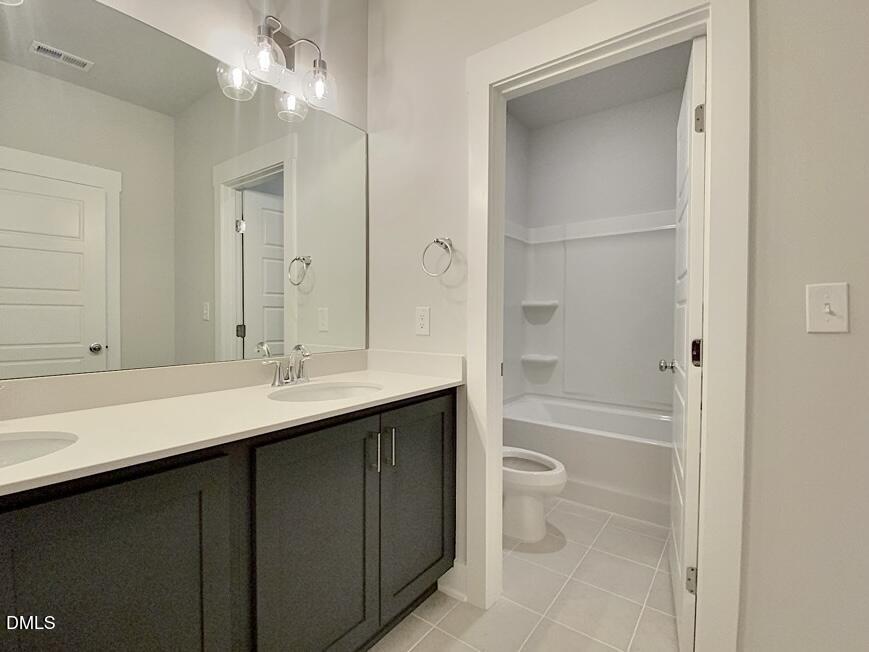 1309 Holding Village Way Wake Forest, NC 27587 - Photo 21 of 28 a bathroom with a sink a toilet and shower